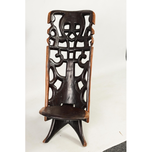 584 - AN AFRICAN TRIBAL HARDWOOD PALAVER CHAIR with figural pierced back (89cm high)