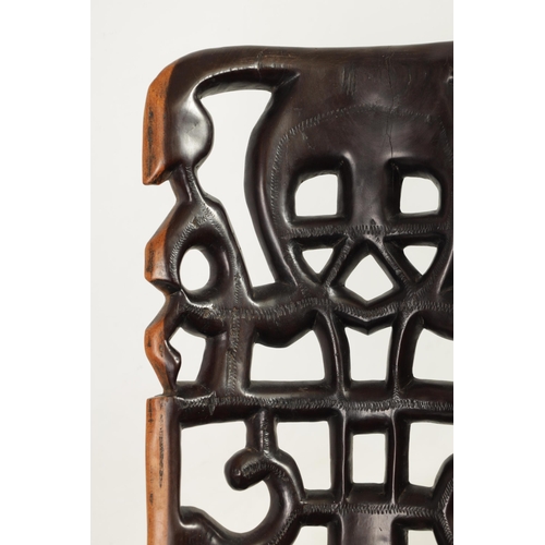 584 - AN AFRICAN TRIBAL HARDWOOD PALAVER CHAIR with figural pierced back (89cm high)