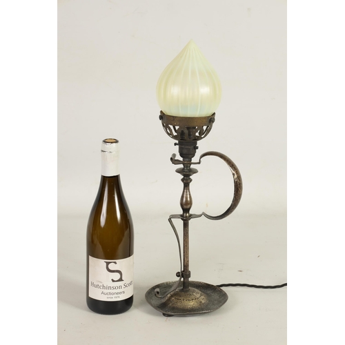 589 - A PATINATED BRASS ART AND CRAFTS TABLE LAMP WITH VASELINE GLASS SHADE surmounted by a cone-shaped sh... 