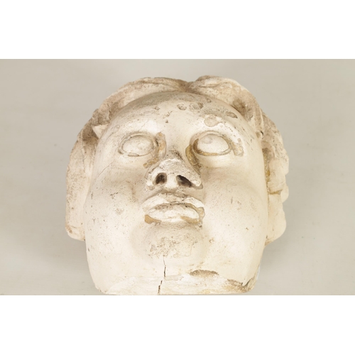 594 - AN 18TH/19TH CENTURY MOULDED PLASTER CHERUBS MASK HEAD with later fixed hanging bracket. (27cm high ... 