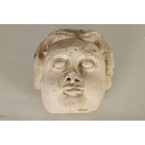 594 - AN 18TH/19TH CENTURY MOULDED PLASTER CHERUBS MASK HEAD with later fixed hanging bracket. (27cm high ... 