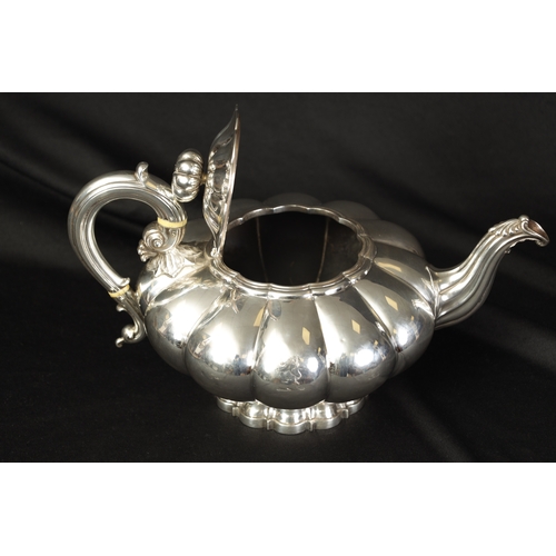 324 - A GEORGE IV FOOTED MELON SHAPED SILVER TEA POT the gadrooned body bearing an engraved lion motif wit... 