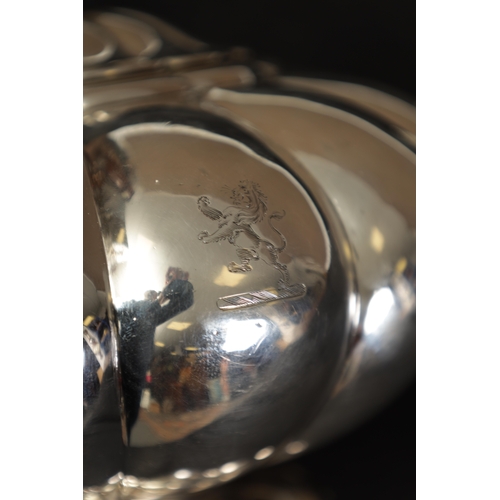 324 - A GEORGE IV FOOTED MELON SHAPED SILVER TEA POT the gadrooned body bearing an engraved lion motif wit... 