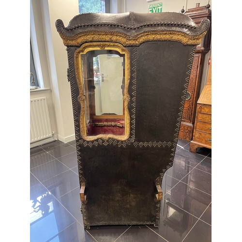 103 - AN EARLY/MID 18TH CENTURY CARVED GILT-WOOD AND STUDDED LEATHER SEDAN CHAIR with shaped domed top abo... 