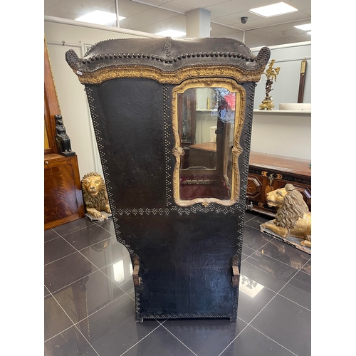 103 - AN EARLY/MID 18TH CENTURY CARVED GILT-WOOD AND STUDDED LEATHER SEDAN CHAIR with shaped domed top abo... 