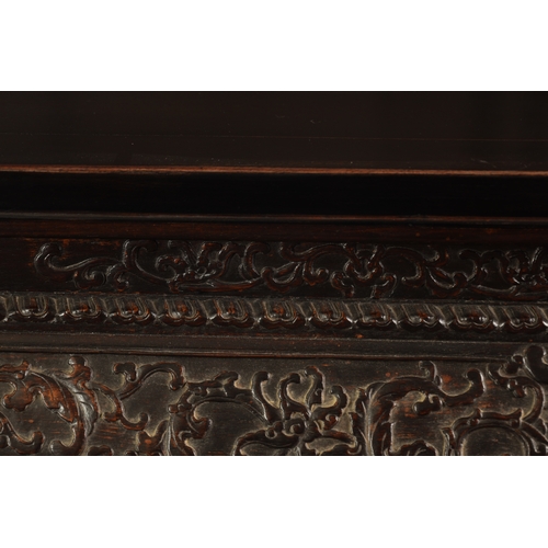 183 - A 20TH CENTURY CHINESE HARDWOOD ALTAR TABLE with inset panelled top above a cushion moulded relief c... 