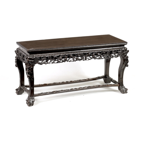 229 - A 19TH CENTURY CHINESE EBONISED HARDWOOD ALTAR TABLE with panelled top above a leaf carved pierced f... 