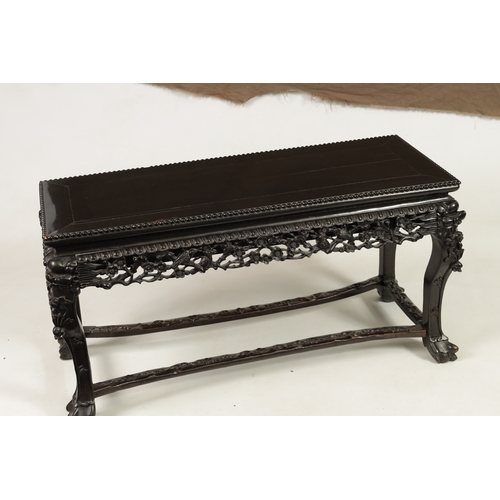 229 - A 19TH CENTURY CHINESE EBONISED HARDWOOD ALTAR TABLE with panelled top above a leaf carved pierced f... 