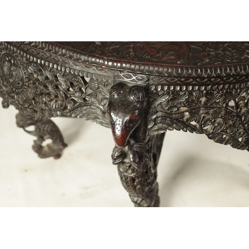 255 - A 19TH CENTURY ANGLO-INDIAN CARVED HARDWOOD DEMI LUNE SERVING TABLE with profusely carved and pierce... 