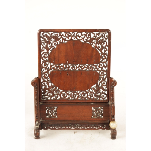117 - A 19TH CENTURY CHINESE CARVED JADE AND HARDWOOD TABLE SCREEN the pierced fret cut frame with leafwor... 
