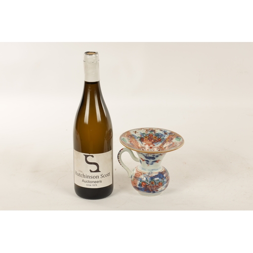 127 - A LATE 19TH CENTURY CHINESE IMARI SPITTOON of squat bulbous form with shaped handle and flared neck,... 