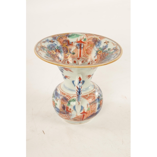127 - A LATE 19TH CENTURY CHINESE IMARI SPITTOON of squat bulbous form with shaped handle and flared neck,... 