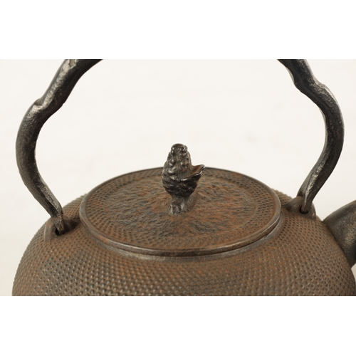 148 - TWO MEIJI PERIOD JAPANESE CAST IRON KETTLES both of squat bulbous form with textured decoration and ... 