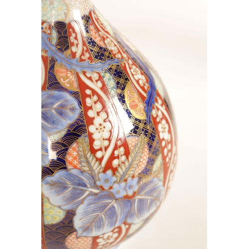 151 - A MEIJI PERIOD JAPANESE BOTTLENECK FUKAGUWA VASE painted with a stylised bird amongst decorative pan... 
