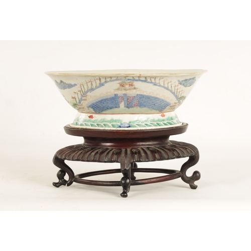 168 - A 19TH CENTURY CHINESE PORCELAIN DISH ON HARDWOOD STAND decorated with landscape views of a palace b... 