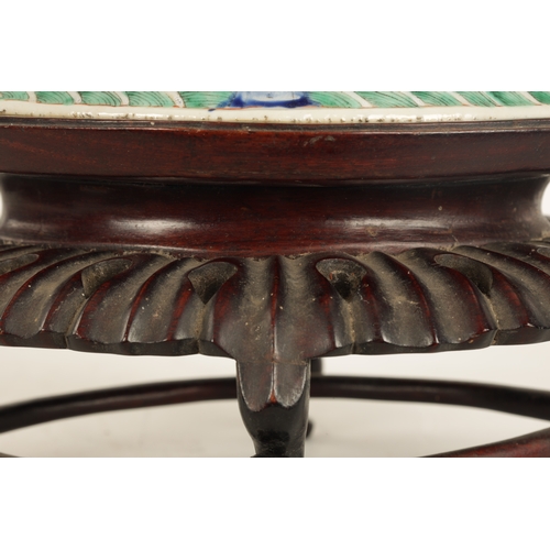 168 - A 19TH CENTURY CHINESE PORCELAIN DISH ON HARDWOOD STAND decorated with landscape views of a palace b... 