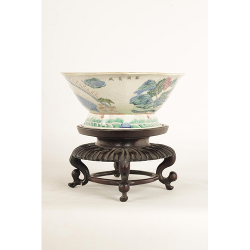 168 - A 19TH CENTURY CHINESE PORCELAIN DISH ON HARDWOOD STAND decorated with landscape views of a palace b... 