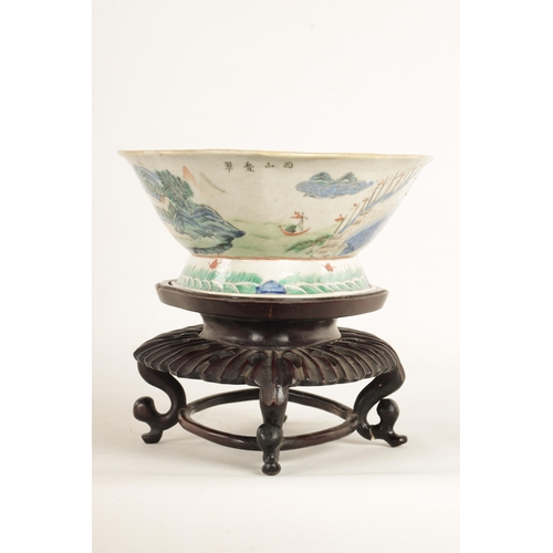 168 - A 19TH CENTURY CHINESE PORCELAIN DISH ON HARDWOOD STAND decorated with landscape views of a palace b... 