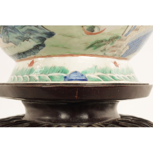 168 - A 19TH CENTURY CHINESE PORCELAIN DISH ON HARDWOOD STAND decorated with landscape views of a palace b... 