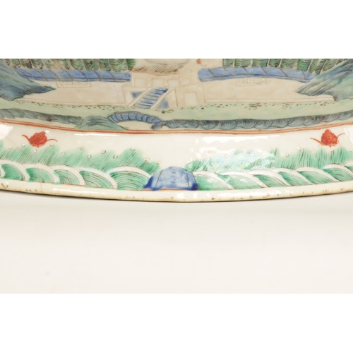 168 - A 19TH CENTURY CHINESE PORCELAIN DISH ON HARDWOOD STAND decorated with landscape views of a palace b... 