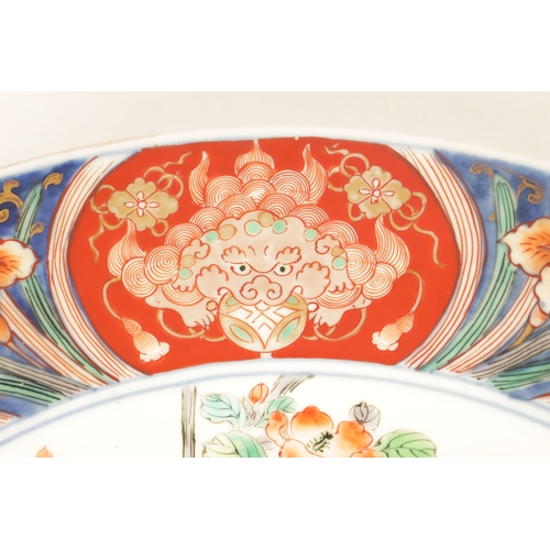 191 - A LATE 19TH CENTURY IMARI LARGE SHALLOW DISH the coloured foliated border with dragon mask head pane... 