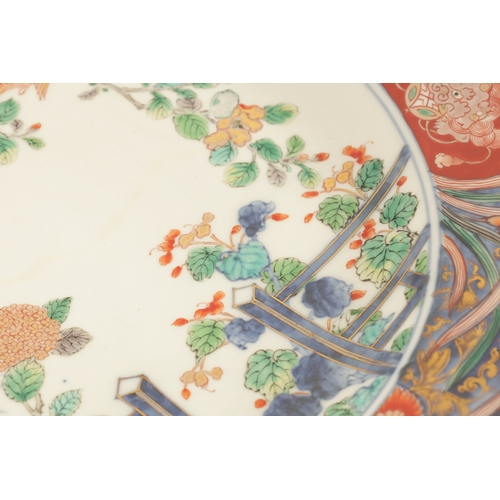 191 - A LATE 19TH CENTURY IMARI LARGE SHALLOW DISH the coloured foliated border with dragon mask head pane... 