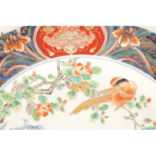 191 - A LATE 19TH CENTURY IMARI LARGE SHALLOW DISH the coloured foliated border with dragon mask head pane... 