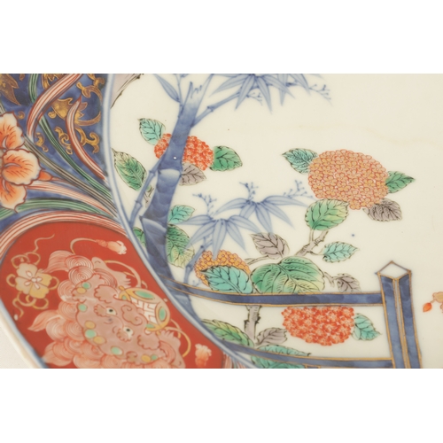 191 - A LATE 19TH CENTURY IMARI LARGE SHALLOW DISH the coloured foliated border with dragon mask head pane... 