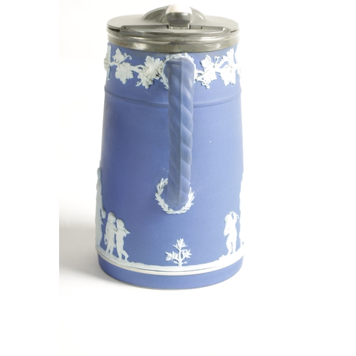 20 - A COLLECTION OF FIVE PIECES OF WEDGEWOOD COLOURED JASPERWARE comprising a biscuit barrel, three jugs... 