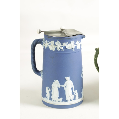 20 - A COLLECTION OF FIVE PIECES OF WEDGEWOOD COLOURED JASPERWARE comprising a biscuit barrel, three jugs... 