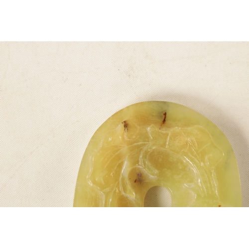 218 - A CHINESE CARVED JADE PENDANT of oval form with relief carved leafwork decoration, engraved decorati... 
