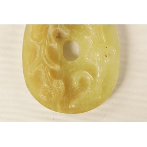 218 - A CHINESE CARVED JADE PENDANT of oval form with relief carved leafwork decoration, engraved decorati... 