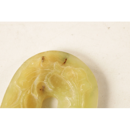 218 - A CHINESE CARVED JADE PENDANT of oval form with relief carved leafwork decoration, engraved decorati... 