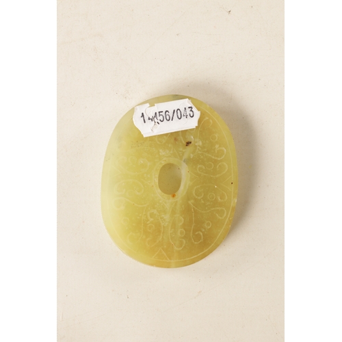 218 - A CHINESE CARVED JADE PENDANT of oval form with relief carved leafwork decoration, engraved decorati... 