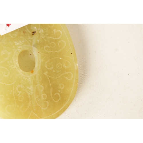 218 - A CHINESE CARVED JADE PENDANT of oval form with relief carved leafwork decoration, engraved decorati... 