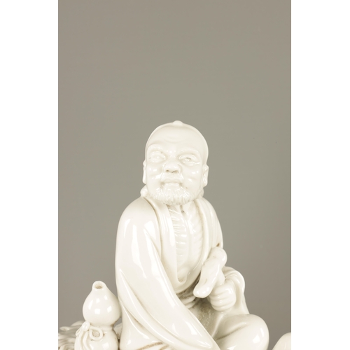 227 - A CHINESE BLANC-DE-CHINE PORCELAIN FIGURE Modelled as Li Tieguai holding his crutch with double gour... 
