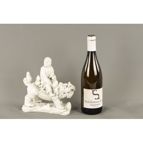227 - A CHINESE BLANC-DE-CHINE PORCELAIN FIGURE Modelled as Li Tieguai holding his crutch with double gour... 