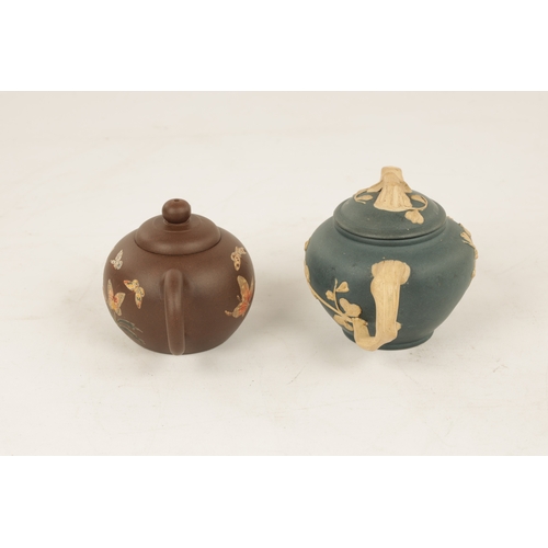 260 - TWO 19TH CENTURY CHINESE TERRACOTTA SMALL TEAPOTS the blue example with branch work handles and spou... 