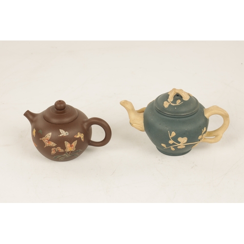 260 - TWO 19TH CENTURY CHINESE TERRACOTTA SMALL TEAPOTS the blue example with branch work handles and spou... 