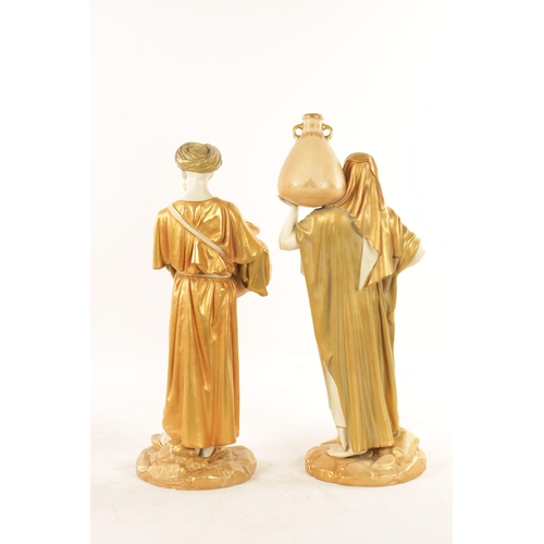32 - A LARGE PAIR OF ROYAL WORCESTER STANDING FIGURES OF EASTERN WATER CARRIERS AFTER JAMES HADLEY depict... 