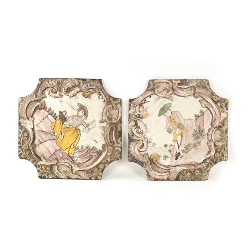 37 - A PAIR OF 18TH CENTURY DELFT POLYCHROME HANGING PLAQUES with shaped raised scrolled leaf and flower ... 