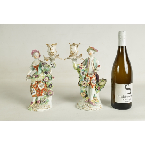 54 - A PAIR OF 19TH CENTURY DERBY FIGURAL CANDLESTICKS depicting a lady and gentleman with encrusted flor... 