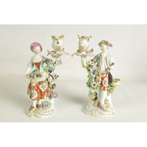 54 - A PAIR OF 19TH CENTURY DERBY FIGURAL CANDLESTICKS depicting a lady and gentleman with encrusted flor... 