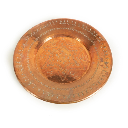 552 - AN ARTS AND CRAFTS HAMMERED COPPER HANGING CHARGER with geometric banded border and flower head star... 