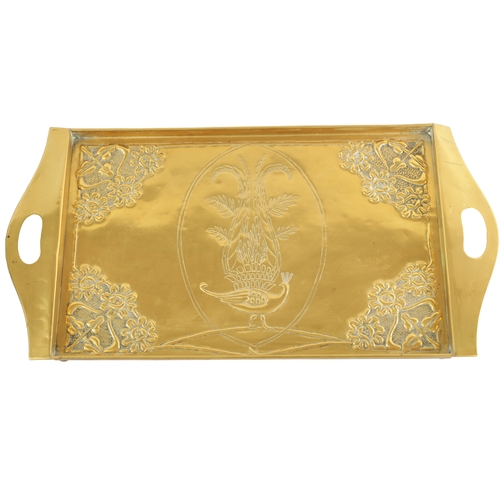 558 - AN STYLISH ARTS AND CRAFTS BRASS RECTANGULAR TRAY with shaped handles to the side and embossed flowe... 