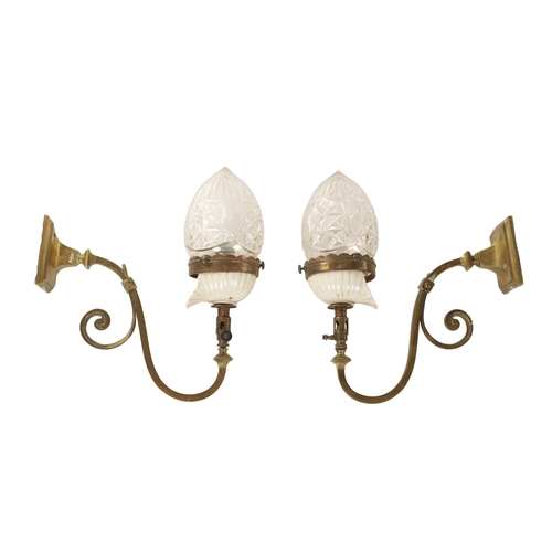 589 - A PAIR OF ELECTRIFIED BRASS WALL LIGHTS with scrolled arms and cut glass pendant shades on brass fit... 