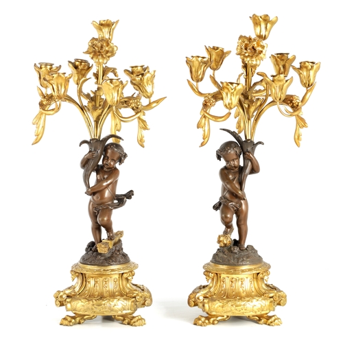 591 - A PAIR OF 19TH CENTURY BRONZE AND ORMOLU SEVEN BRANCH CANDLELARBRA with leaf and flower head decorat... 