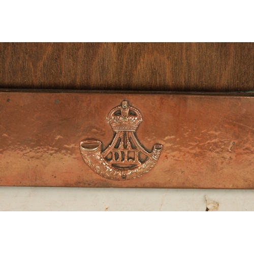 543 - AN ARTS AND CRAFTS COPPER FRAMED PICTURE FRAME IN THE LIBERTYS STYLE bearing military motif. (36.5cm... 