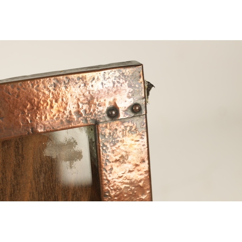 543 - AN ARTS AND CRAFTS COPPER FRAMED PICTURE FRAME IN THE LIBERTYS STYLE bearing military motif. (36.5cm... 