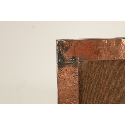 543 - AN ARTS AND CRAFTS COPPER FRAMED PICTURE FRAME IN THE LIBERTYS STYLE bearing military motif. (36.5cm... 